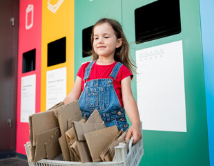 Portrait of cute girl holding box with cardboard for reduce, reuse, recycle. Concept of care for...