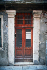 Venice Italian retro wood style front door with glass, the main entrance. Element of the classic Italian Venetian facade and architecture