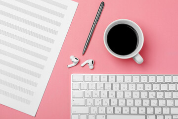 Notebook for writing notes and a cup of coffee on a pink background