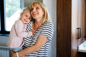 Single mother concept. Happy mother with her little girl spendig time together at home.