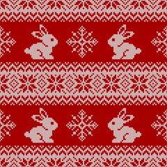 Fototapeta na wymiar Knitted seamless pattern for 2023 New Year of the Rabbit. Vector background with cute bunnies, snowflakes, and traditional scandinavian ornaments. Red and white sweater print.