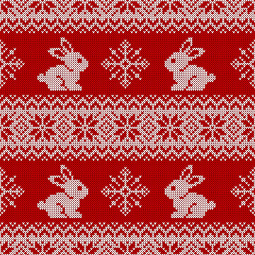 Knitted seamless pattern for 2023 New Year of the Rabbit. Vector background with cute bunnies, snowflakes, and traditional scandinavian ornaments. Red and white sweater print.