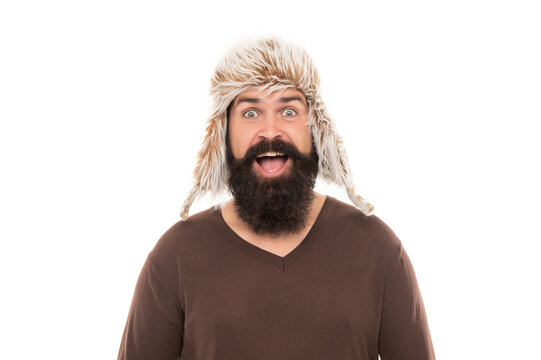 amazed bearded man with moustache in earflape hat isolated on white background, expression