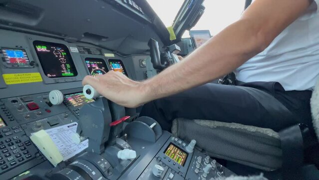 Close view of the flight controls and engine throttles, copilot side, during the approach. Daylight. 4K.