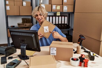 Young blond man ecommerce business worker having video call at office