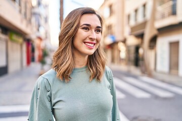 Fototapeta premium Young woman smiling confident standing at street