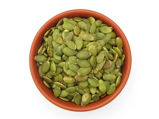 Green pumpkin seeds in a bowl top view 