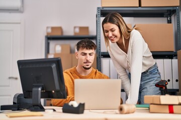 Young man and woman ecommerce business workers having video call at office