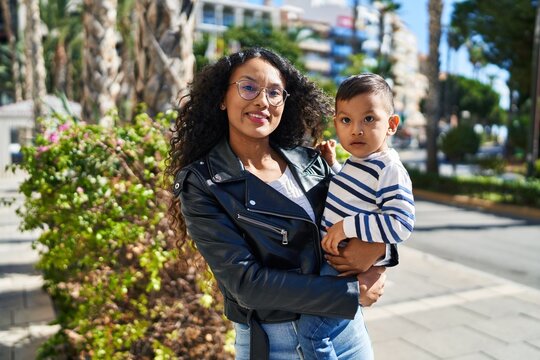 Mother and son hugging each other standing at park