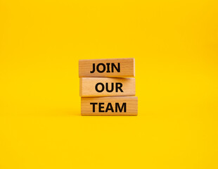 Join our team symbol. Wooden blocks with words Join our team. Beautiful yellow background. Business and Join our team concept. Copy space.