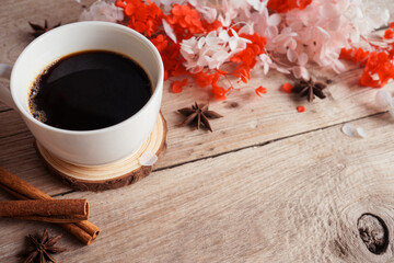 Obraz na płótnie Canvas black coffee on the wooden table with dry flowers for autumn theme