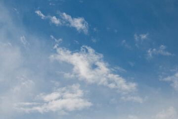 Summer blue sky, curly cloud, light white background. The beauty of cloudiness in the sunlight is calm and bright. bright blue landscape in environment day