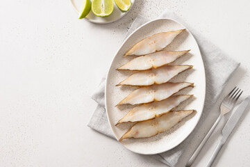 Smoked halibut slices on white background. View from above. Copy space.