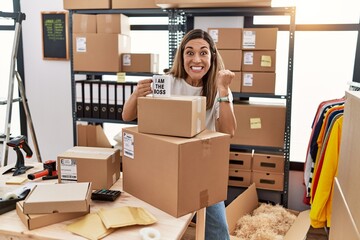 Young hispanic woman drinking coffee at online shop screaming proud, celebrating victory and success very excited with raised arms