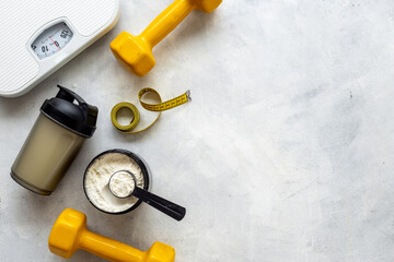 Sports nutrition background. Whey protein in jar and shaker bottle