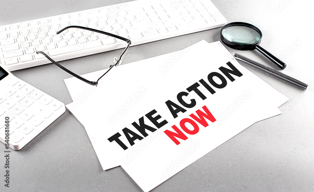 Poster take action now text on a paper with keyboard, calculator on grey background