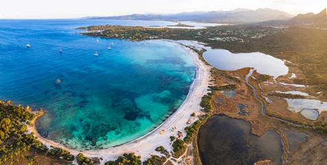 Poster Sardegnia island nature scenery and best beaches. Aerial drone panoramic view of beautiful Lu Impostu beach and salt lakes over sunset. Italy summer holidays © Freesurf