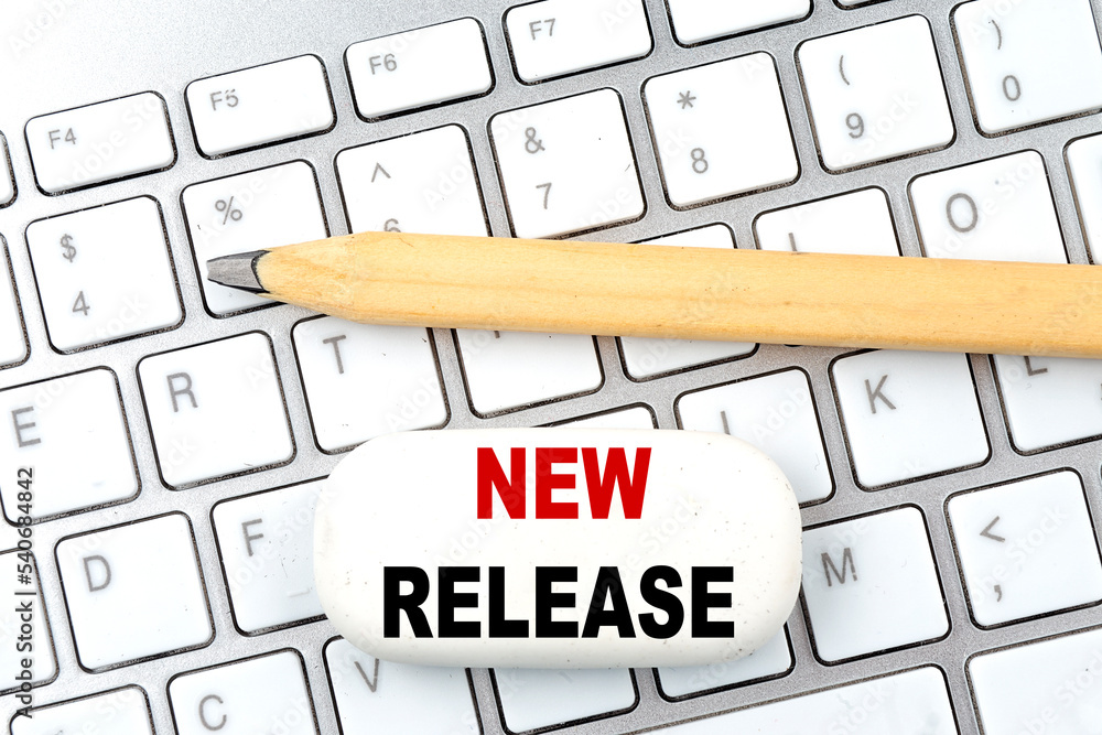 Poster new release text on eraser with pencil on keyboard