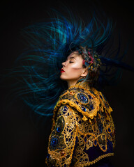 Fashion female portrait with avantgarde hair style at black background. Woman in matador suit with blue long hair. Expressive shot of hairdressing art. - obrazy, fototapety, plakaty