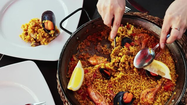Traditional dish of Spanish cuisine is paella with seafood, made from rice, tinted with saffron, with the addition of the gifts of the sea and decorated with a slice of lemon.