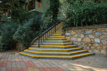 stairs with yellow stripes for people with poor eyesight