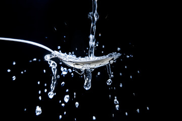Water falling on a spoon