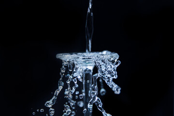 Water falling on to a upside down glass