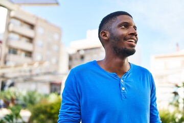 Young african american man smiling confident standing at street