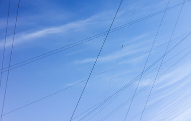 Fototapeta premium Power cables and wires are under blue cloudy sky,