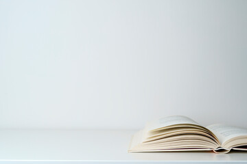 Open book on the table. A book with a white page on a light empty background. Education, school,...