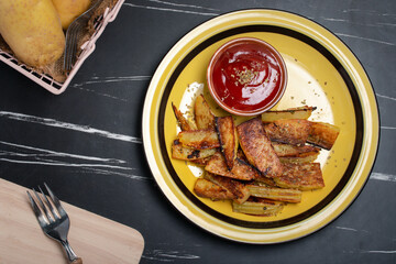 Salt-grilled potatoes with tomato sauce. Fast food restaurant