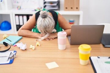 Middle age grey-haired woman business worker stressed using laptop at office