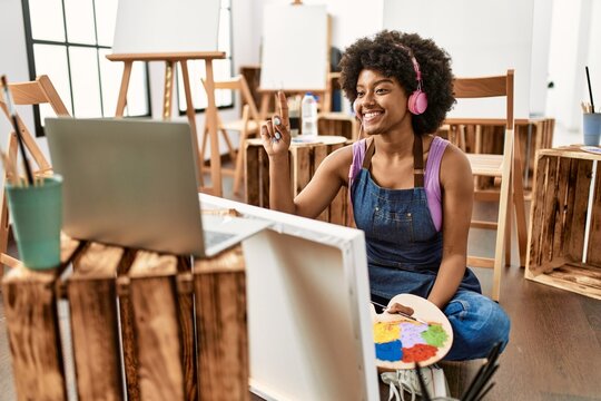 Young african american woman having online drawing class at art studio