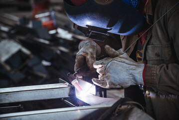 Industrial welder welding fabricated stainless construction work in factory, Welding process by Gas...