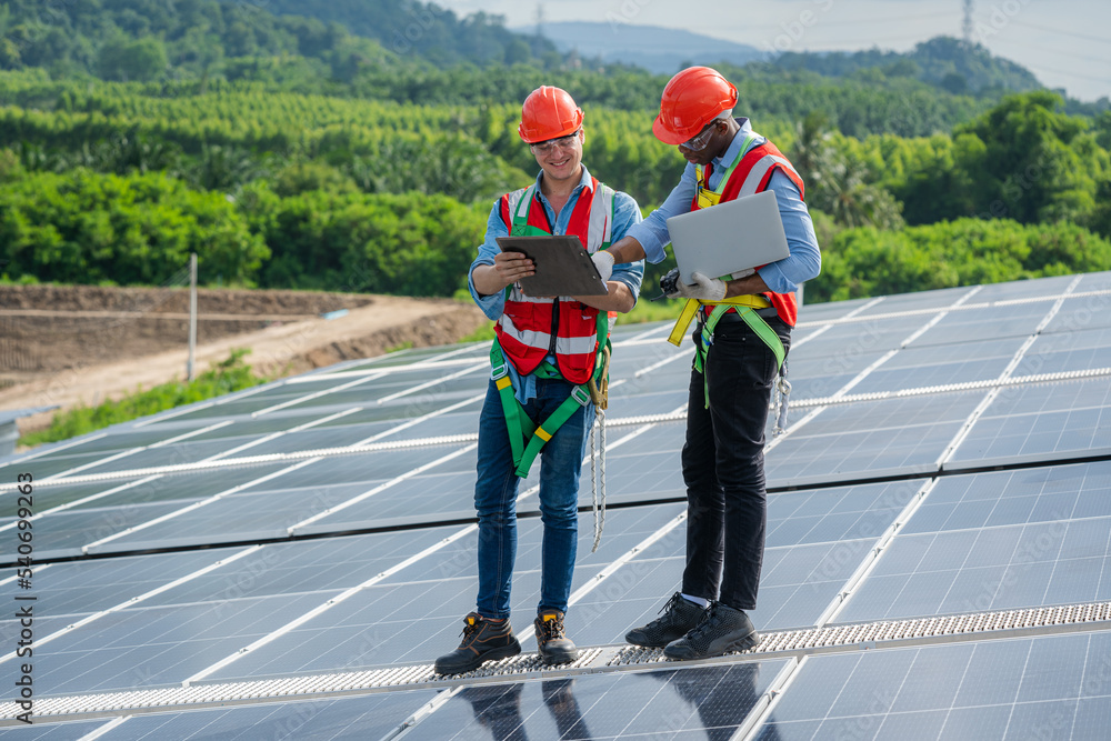 Poster engineer and technician working and checking on solar panels on roof of factory,solar panel,alternat
