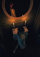 Fototapeta na wymiar Young woman by a mirror with a table and candlelights in an classical room at night. 3D render.