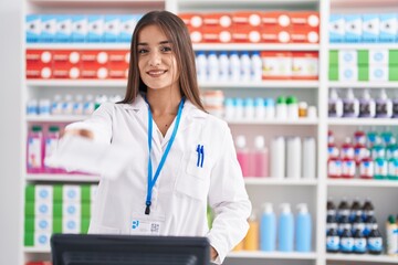 Young beautiful hispanic woman pharmacist holding prescription paper at pharmacy