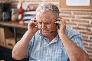 Middle age grey-haired man call center agent working at office
