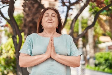 Senior woman doing yoga exercise at park