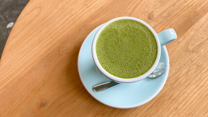 drink, diet, weight-loss and slimming concept - cup of matcha green tea latte over white