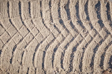Fototapeta na wymiar Tire tracks in the sand on a sunny day
