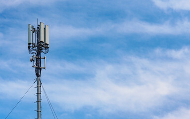 Cellular network antenna against blue sky.