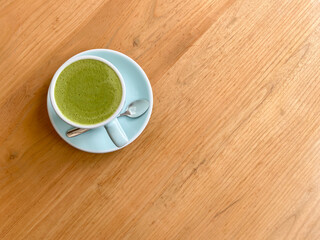 drink, morning, drink and people concept - hands of young woman with cup of matcha tea