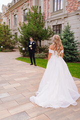 first meeting. Beautiful bride and groom blonde near the classic building. 