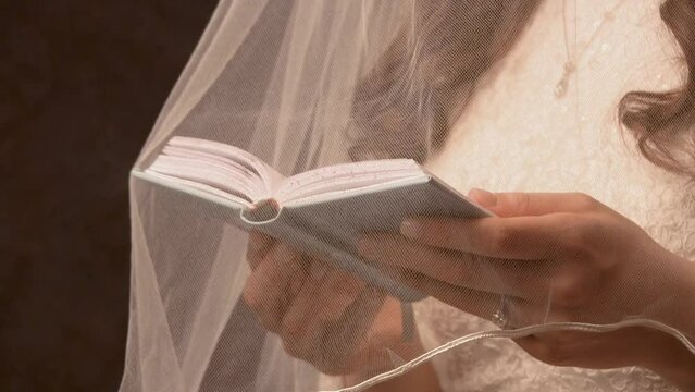 Jewish woman reading scripture under her vail