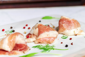 Bacon slide with herb on white marble plate background.