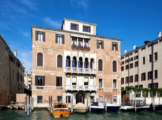 Architecture of Venice, Italy. Palazzo and historic houses in the water of Grand Canal. Traditional Venetian architecture with reflections in water.
