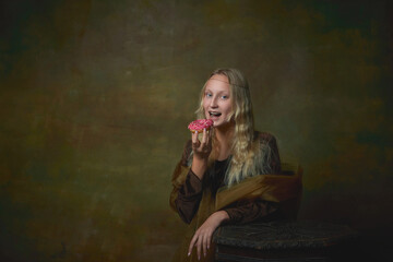 Sweet donut. Vintage style portrait of young charming girl in image of Mona Lisa, La Gioconda isolated on dark green background. Art, beauty, style, imitation