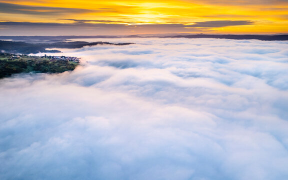 Germany, Baden-Wurttemberg, Drone view of Rems Valley shrouded in thick autumn fog at sunrise