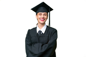 Young university graduate  caucasian woman over isolated background keeping the arms crossed in...